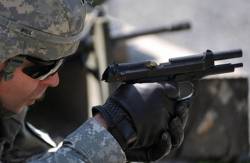 Un soldado del ejército americano con la pistola Beretta M9 - 93