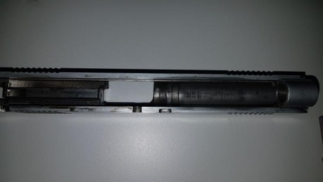 Pistola SPS no se el modelo exacto, junto a SOS pone World Custom, y en el otro lado de la corredera PLUS

Calibre 91